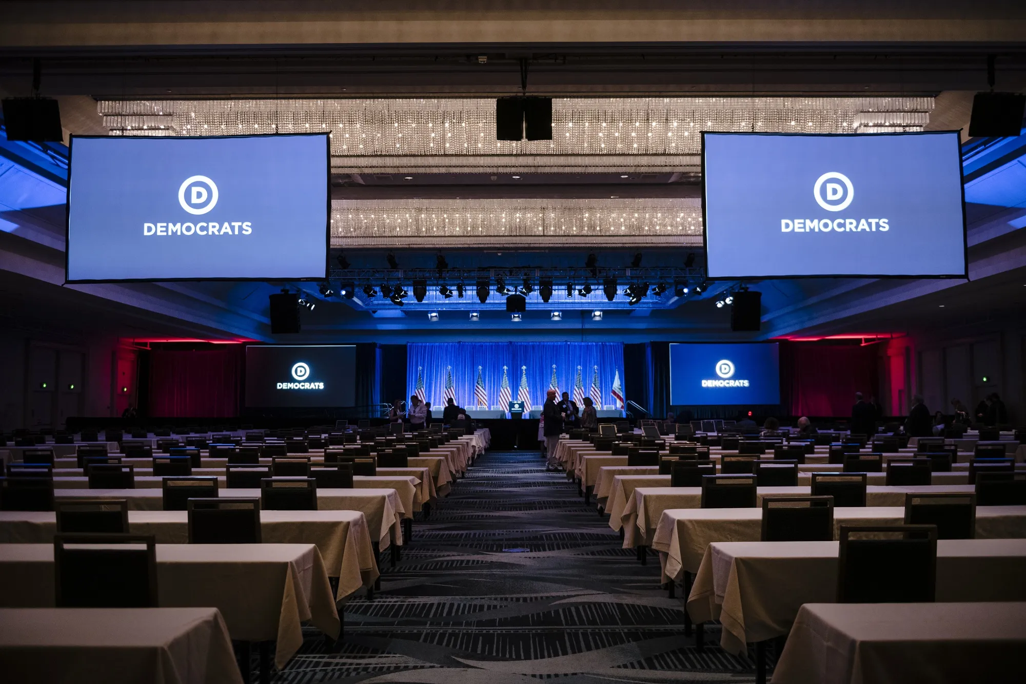 Signage is displayed on monitors during the Democratic National Committee (DNC) Summer Meeting in San Francisco, California, U.S., on Friday, Aug. 23.