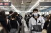 Commuters walking through a train station in Beijing.