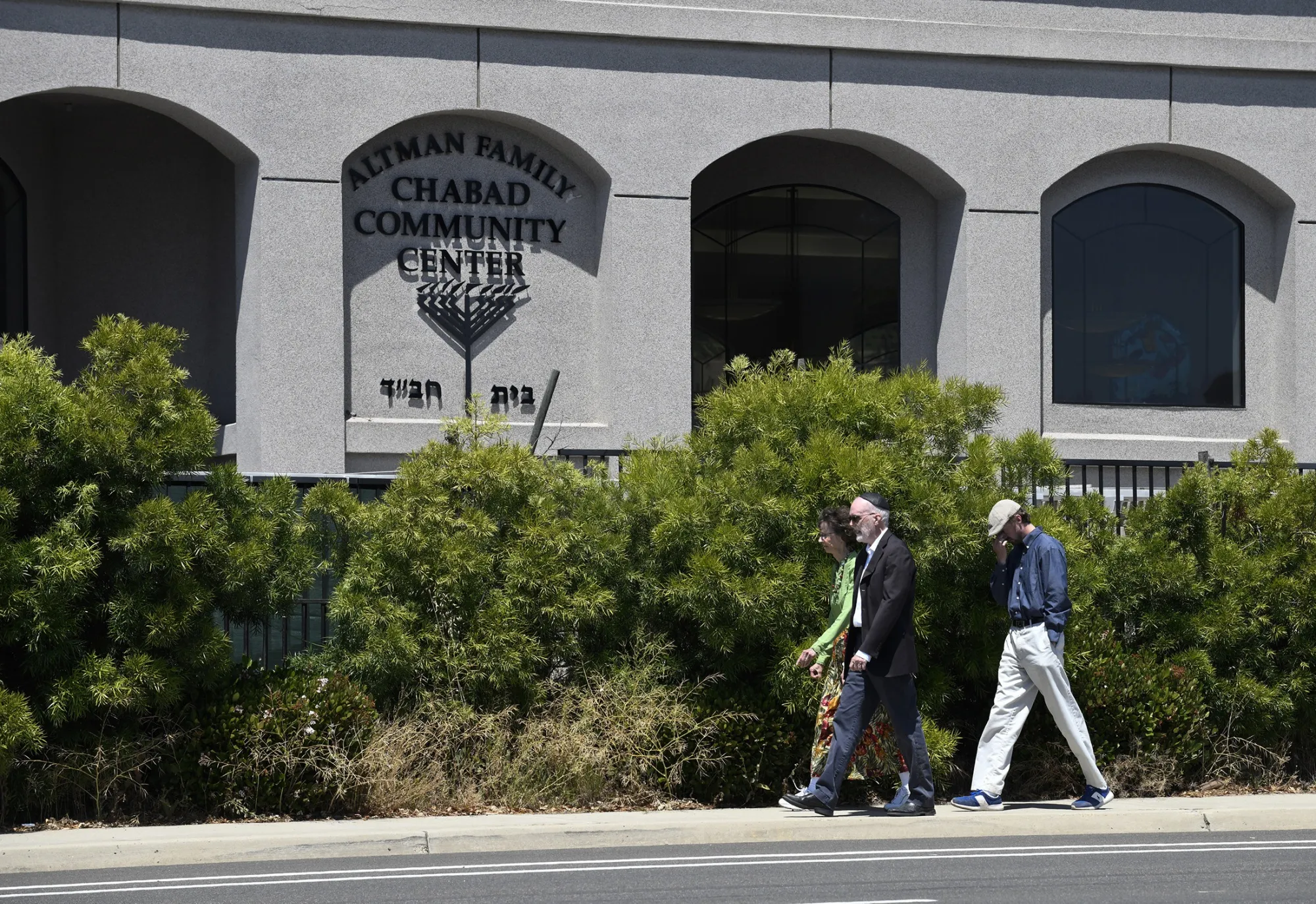 Synagogue members walk outside of the Chabad of Poway Synagogue Saturday, April 27, 2019, in Poway, California.
