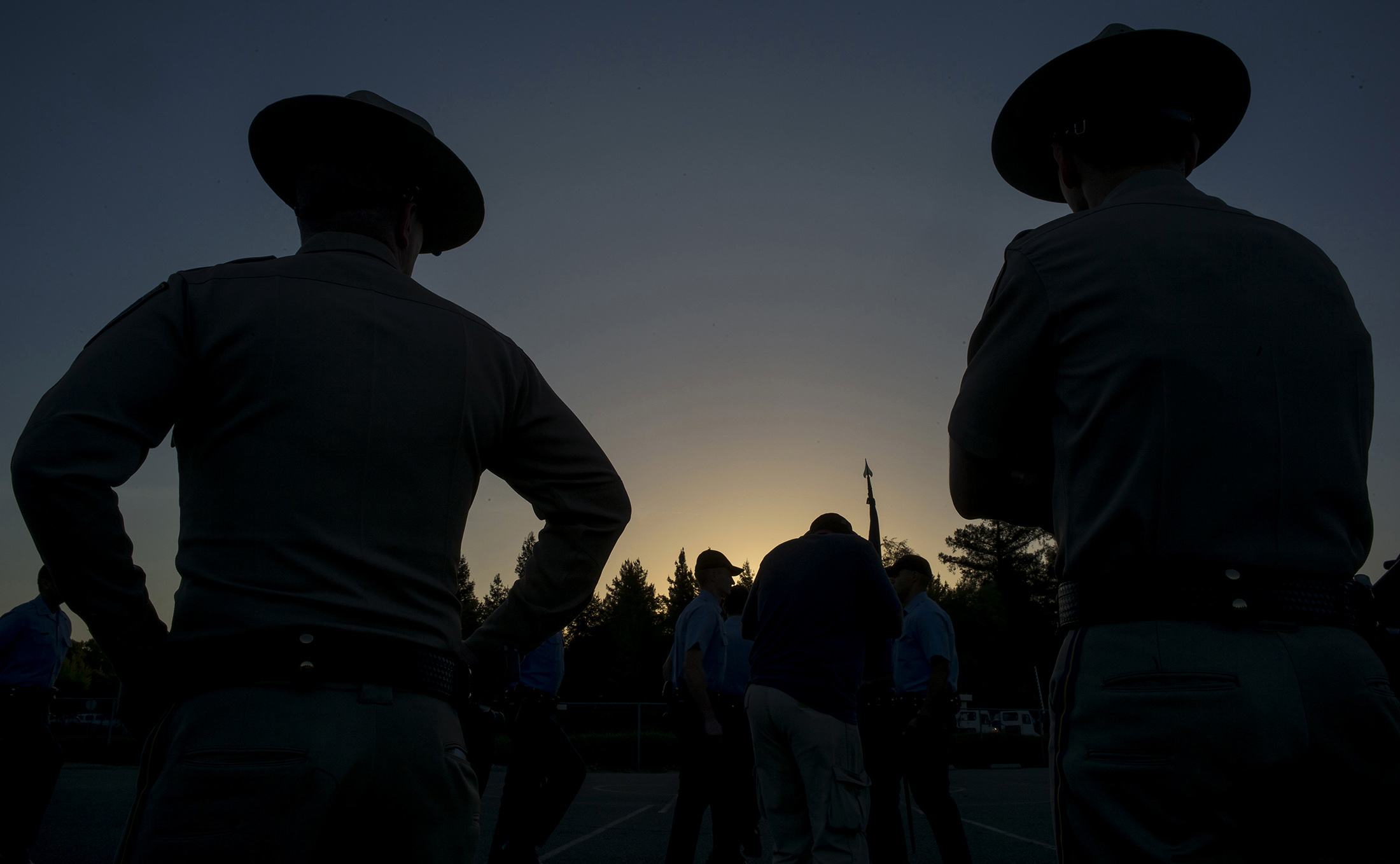 Training officers watch over cadets as they march in formation at the California Highway Patrol Academy in West Sacramento, California.
