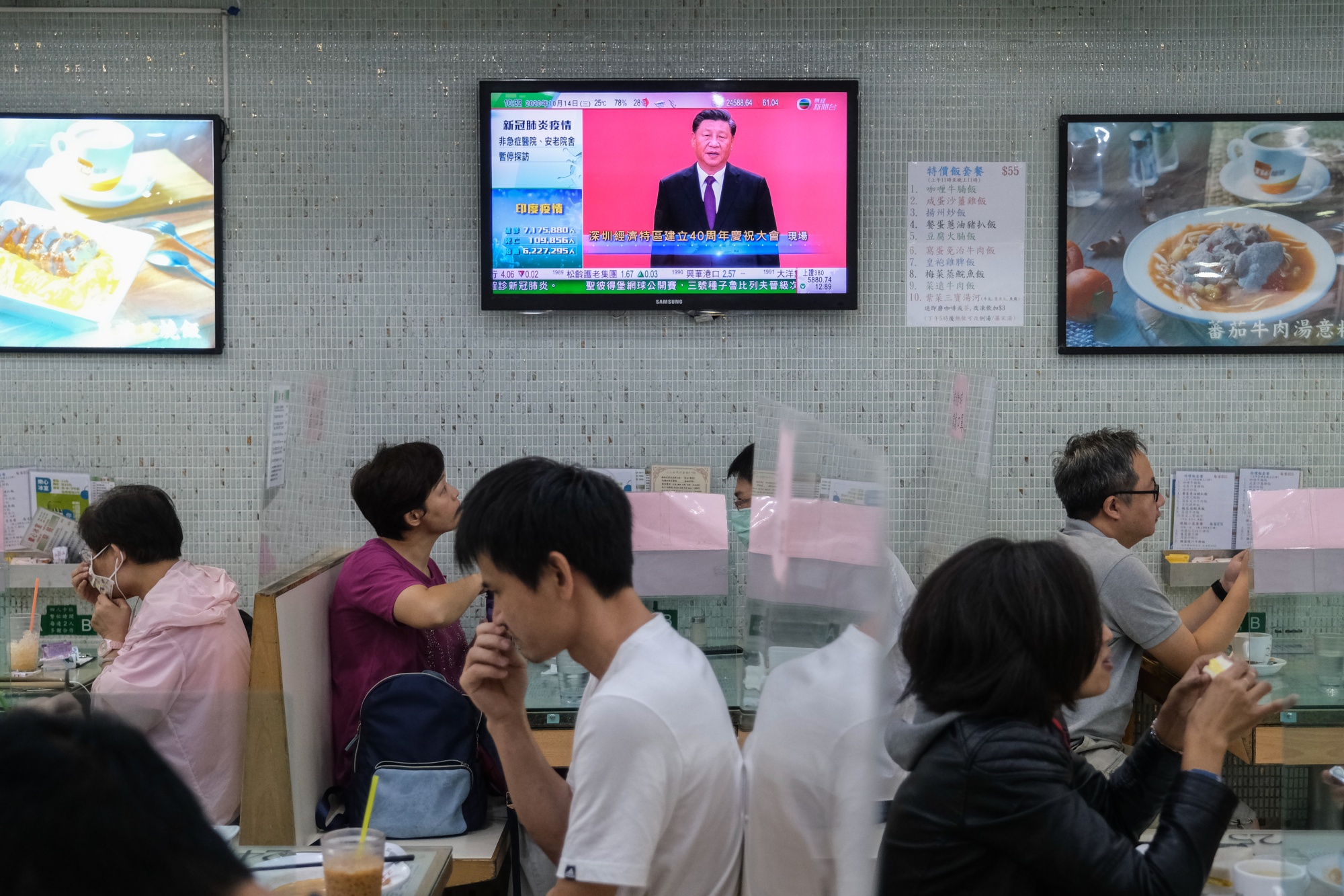 A live broadcast of Xi Jinping delivering a speech in the city of Shenzhen is shown on a screen inside a restaurant in Hong Kong on Oct. 14.