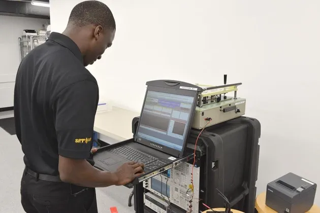 A technician prepares a VIPturbo Modem at the SRT Wireless satellite communications manufacturing plant in Davie, Florida on Aug. 18