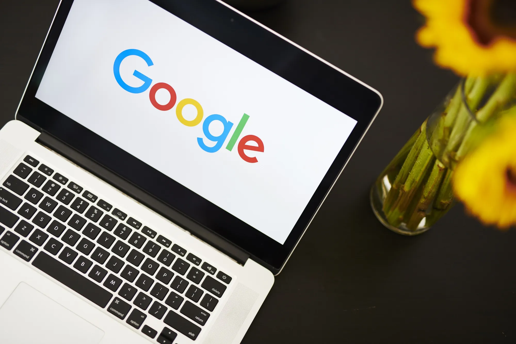 The Google logo on an Apple laptop computer.