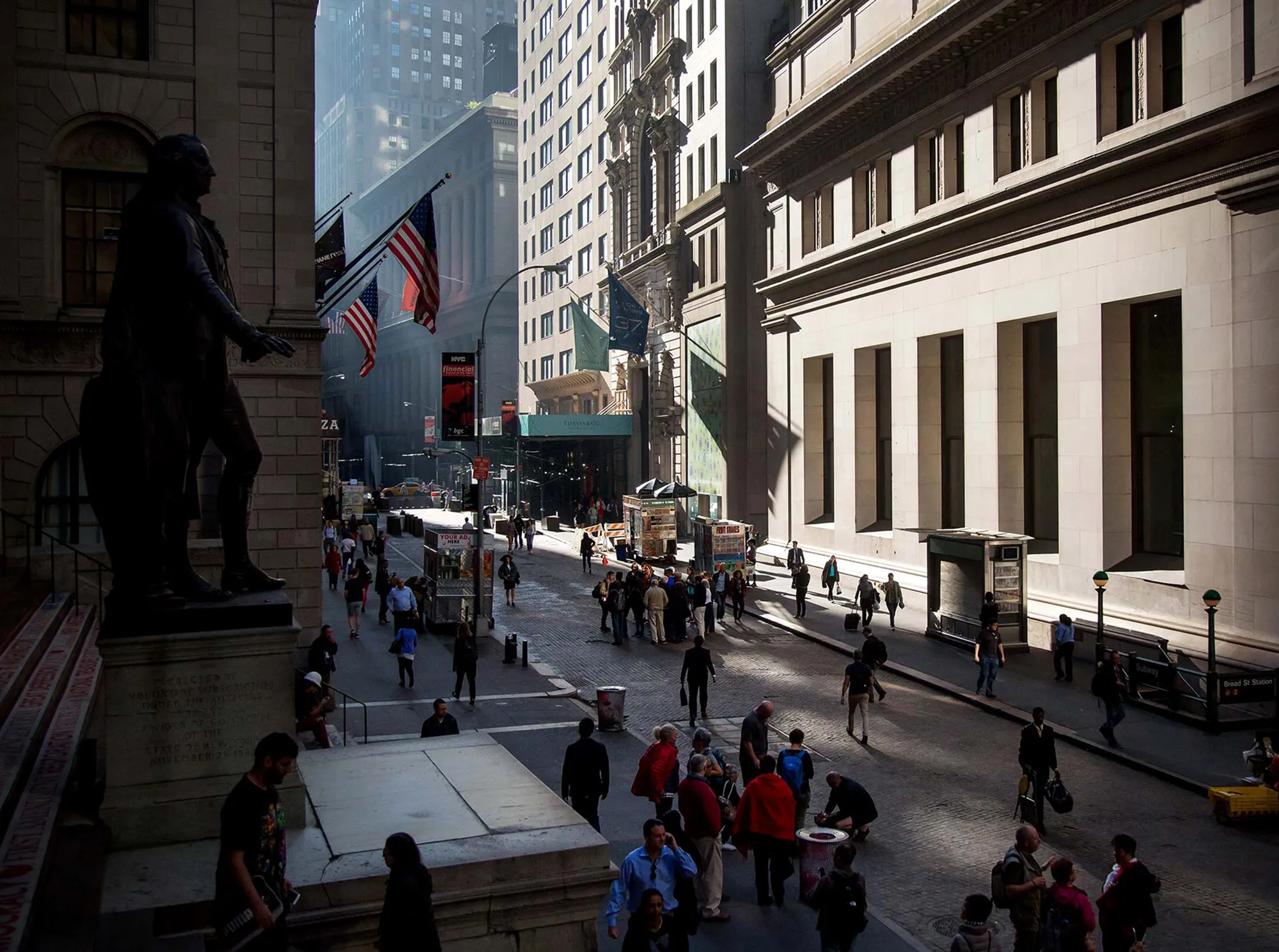Pedestrians walk near the New York Stock Exchange.
