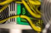 A bitcoin logo sits on a LL 1800W power unit supplying cryptocurrency mining machines at the SberBit mining \'hotel\' in Moscow, Russia, on Saturday, Dec. 9, 2017. Futures on the world’s most popular cryptocurrency surged as much as 26 percent in their debut session on Cboe Global Markets Inc.\'s exchange, triggering two temporary trading halts designed to calm the market.
