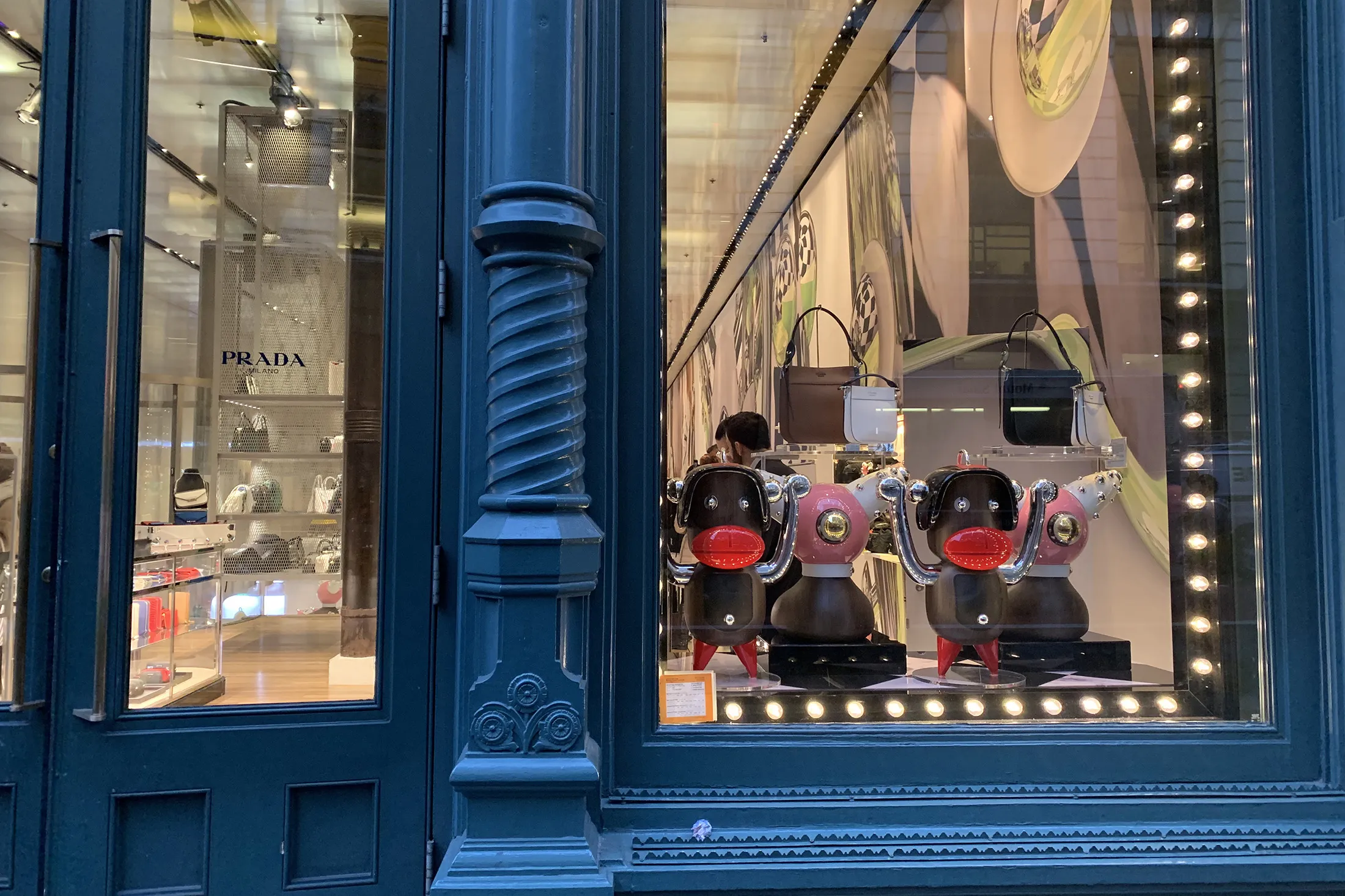 Prada store with "Pradamalia" figures on display. 