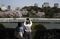 A man uses a tablet device to take a photograph of cherry trees in blossom in Tokyo, Japan, on Tuesday, March 31, 2015. Japan's emergence from recession was weaker than first estimated as companies unexpectedly cut investment and drew down their inventories, offsetting a pickup in consumer spending. Photographer: Tomohiro Ohsumi/Bloomberg