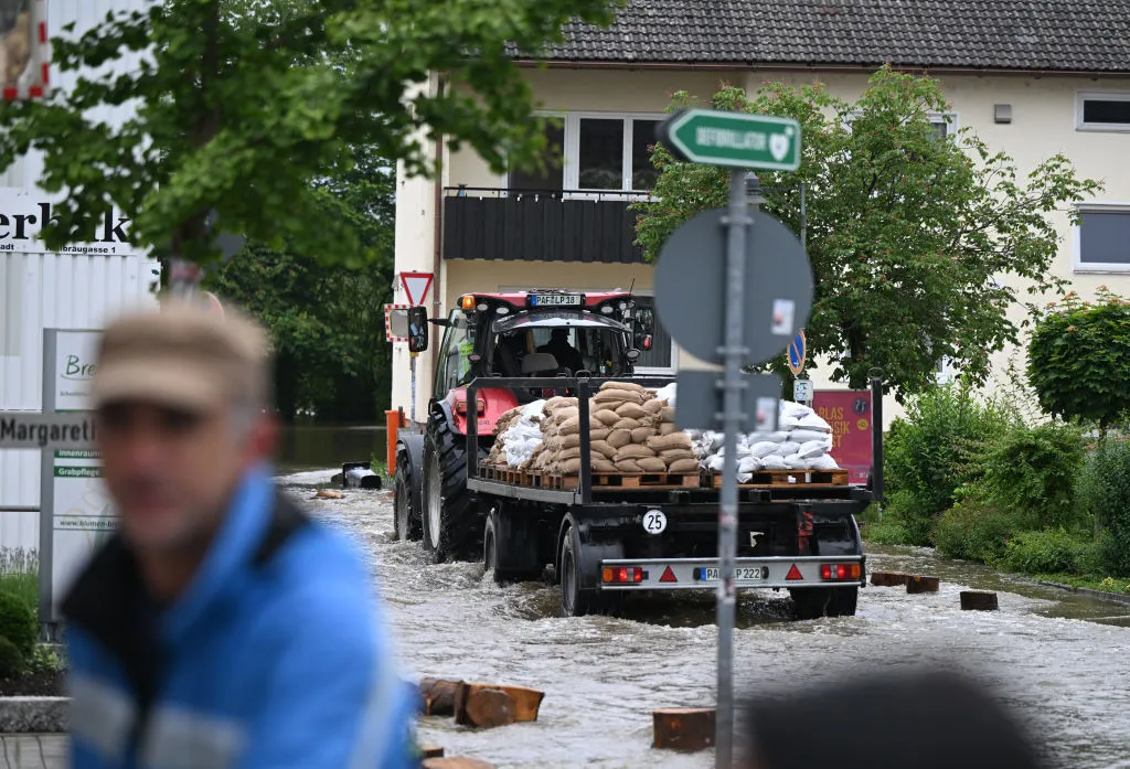 A tractor carries sandbags in a flooded street in Reichertshofen, on June 2.&nbsp;