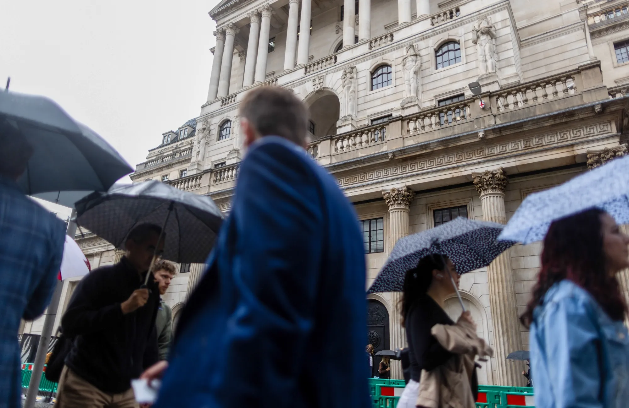 Commuters pass the Bank of England in the City of London.
