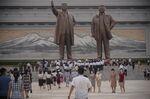 People prepare to pay their respects to the statues of late North Korean leaders Kim Il Sung and Kim Jong Il&nbsp;at Mansu Hill in Pyongyang, on July 7.