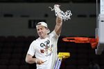 Louisville head coach Jeff Walz cuts down a net after beating Michigan 62-50 in a college basketball game in the Elite 8 round of the NCAA women's tournament Monday, March 28, 2022, in Wichita, Kan. (AP Photo/Jeff Roberson)