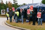 Workers hold signs during a strike outside the John Deere Regional Parts Distribution facility in McDonough, Georgia,&nbsp;on&nbsp;Nov. 5.&nbsp;