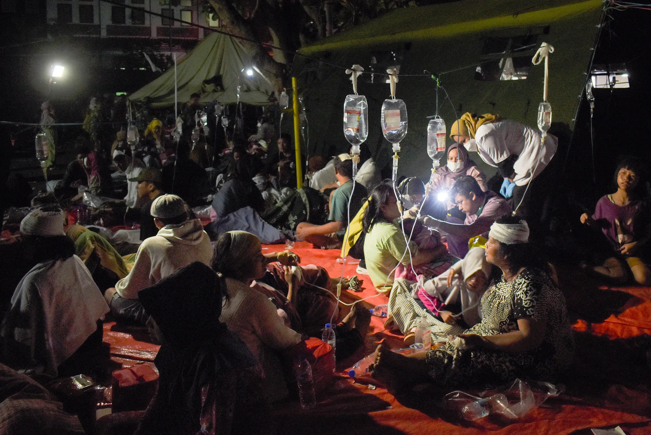 Wounded survivors are&nbsp;treated in the yard of a hospital in Cianjur on Nov. 21.