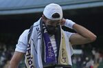 Italy's Matteo Berrettini wears a mask at the end of the third set during the men's singles quarterfinals match against Canada's Felix Auger-Aliassime on day nine of the Wimbledon Tennis Championships in London, Wednesday, July 7, 2021. At Wimbledon, where the All England Club is following British government COVID guidance that requires neither shots nor testing, three of the top 20 seeded men have withdrawn over the first four days of action because they got COVID-19, with No. 17 Roberto Bautista Agut pulling out Thursday, June 30, 2022. (AP Photo/Alberto Pezzali, File)