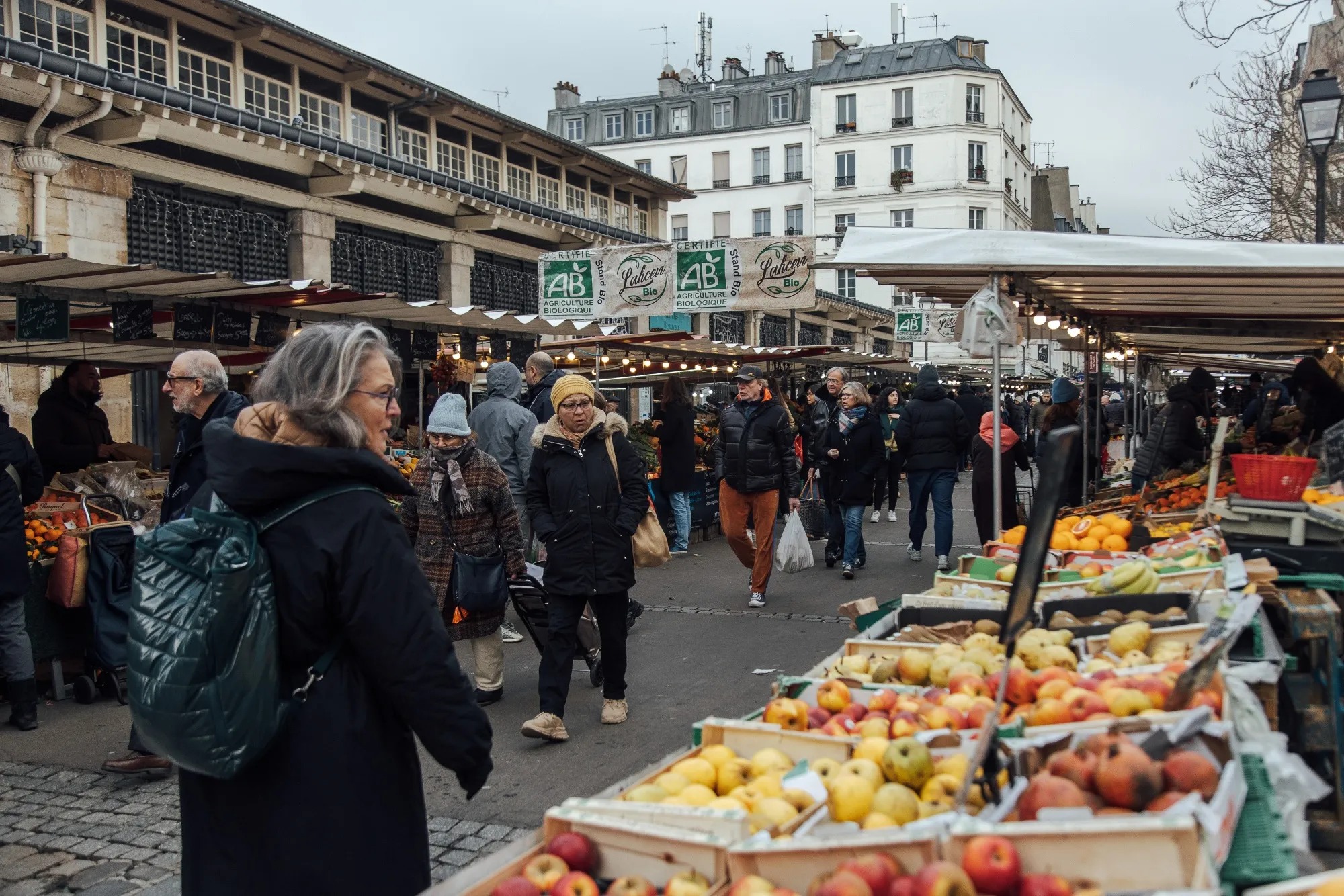 Customers shop for fresh produce at the Beauvau market in Paris.