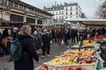 Customers shop for fresh produce at the Beauvau market in Paris, France, on Saturday, Jan. 11, 2025. France’s new Finance Minister Eric Lombard set out a slower pace of deficit reduction as he seeks to preserve economic growth