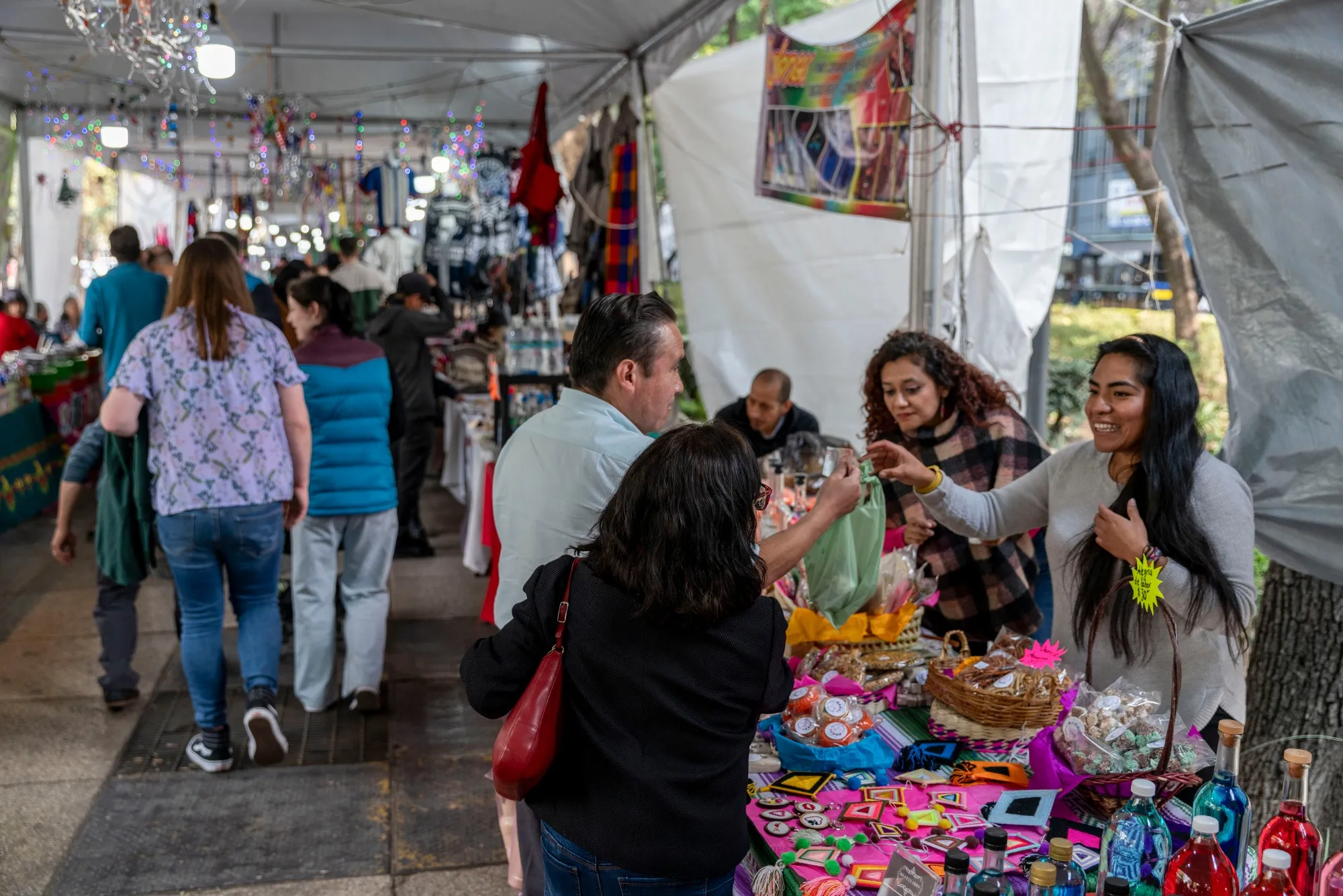 A worker assists shoppers at a market in Mexico City.