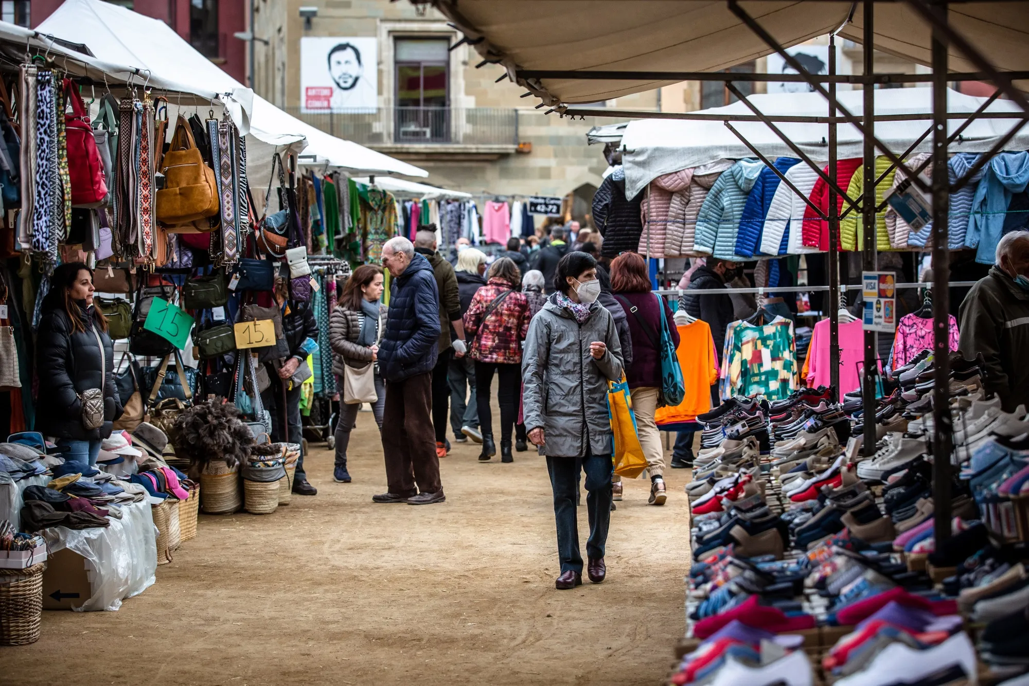 A shopper browses a market in the Plaza Mayor of Vic, Spain, on April 12.