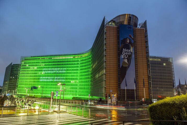 The Berlaymont building lit in green.