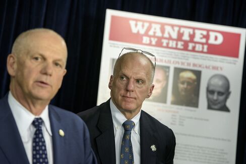 FBI Assistant Director for Cyber Security Joseph Demarest (right) listens while U.S. Attorney for the Western District of Pennsylvania David Hickton speaks during a briefing at the Foreign Press Center Feb. 24 in Washington.
