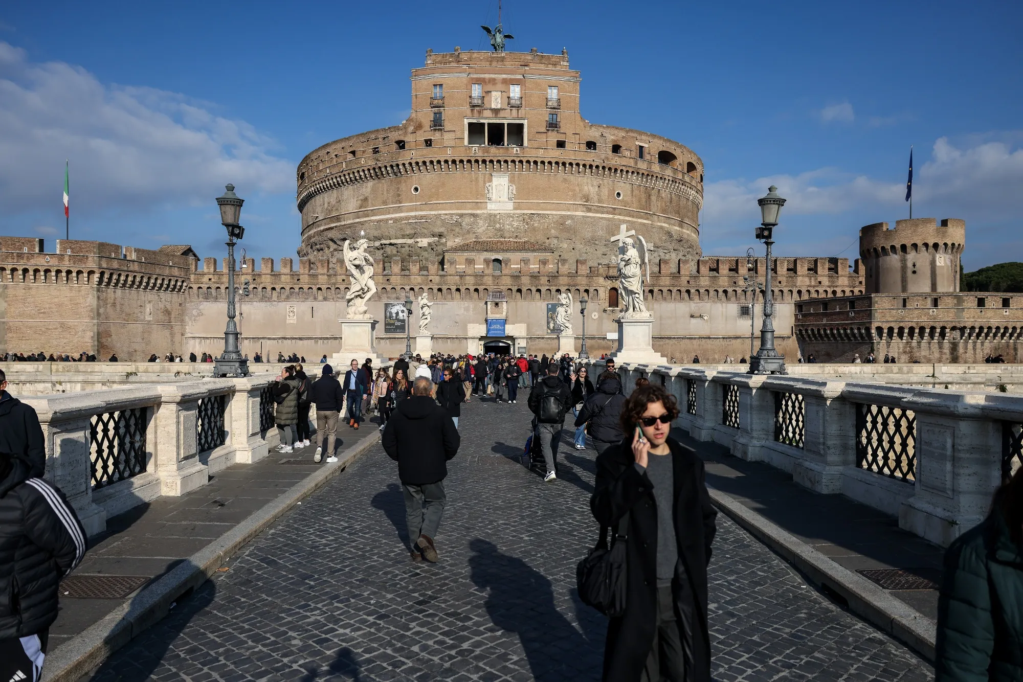 Pedestrians at St. Angel castle in Rome, Italy.