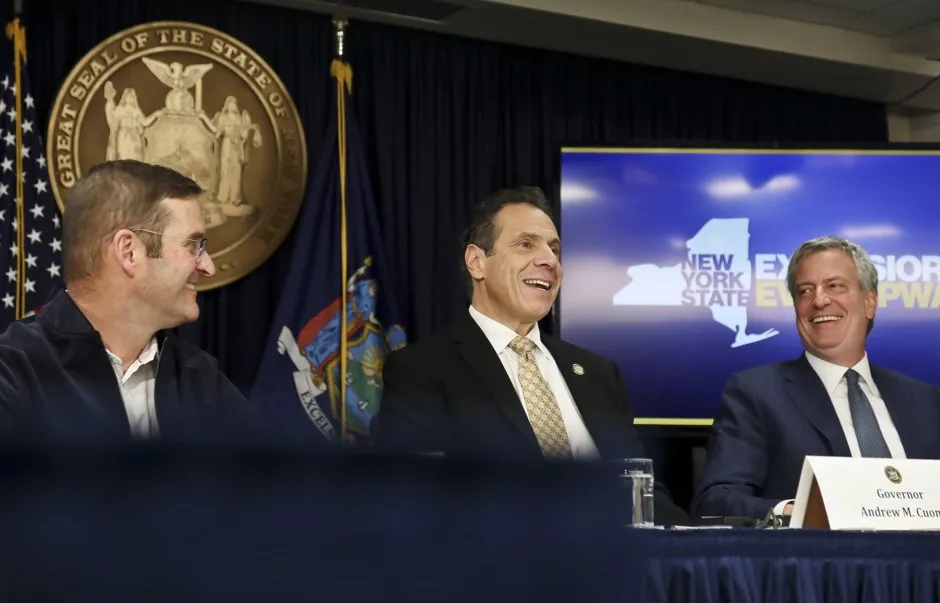John Schoettler, Amazon vice president for real estate and facilities, joins New York Gov. Andrew Cuomo, center, and New York City Mayor Bill de Blasio during a news conference to announce the Amazon deal.