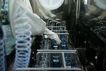 An employee works with sterile products during the manufacture of pharmaceuticals inside Teva Pharmaceutical Industries Ltd.'s in Godollo, Hungary.