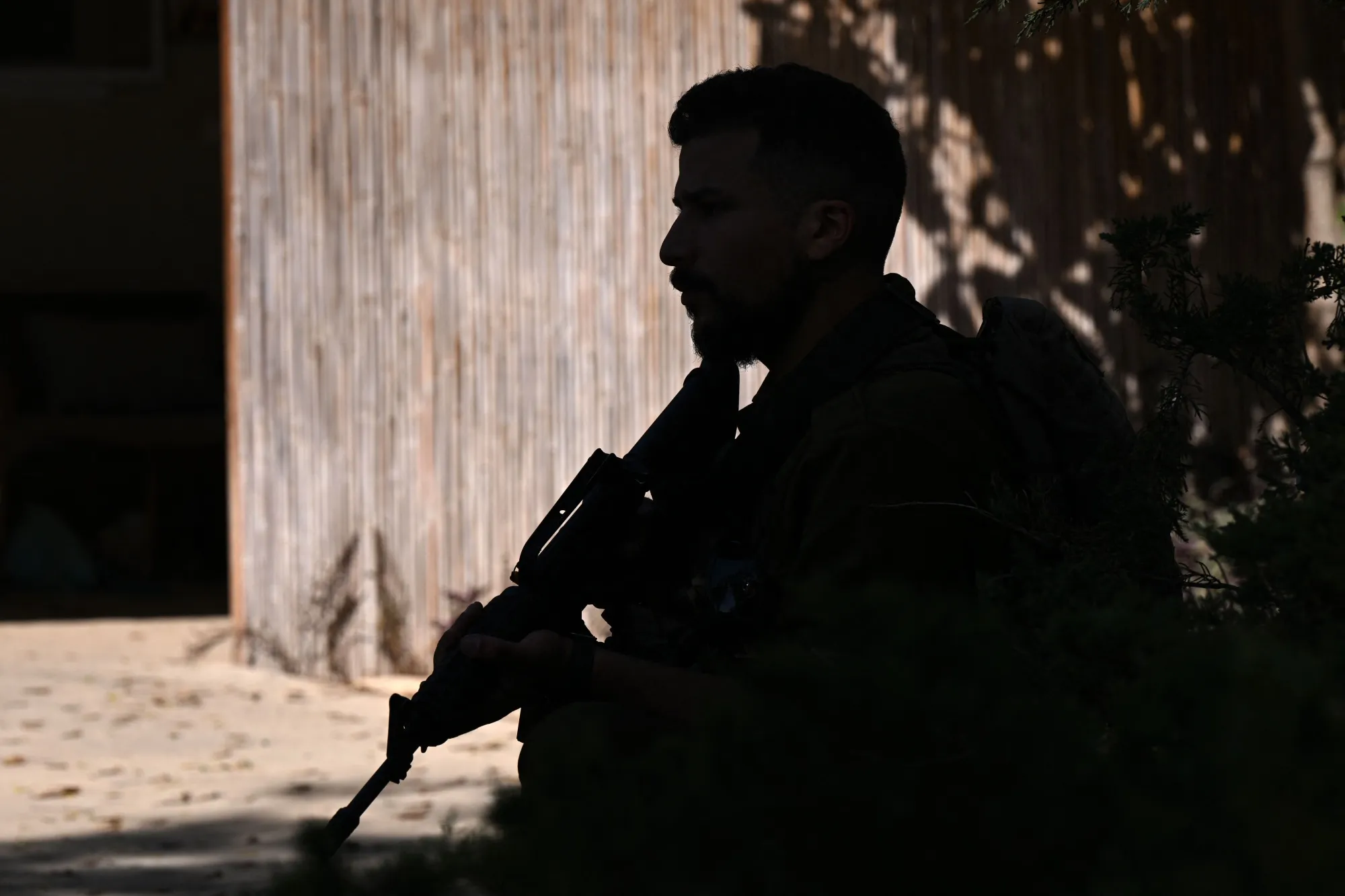 An Israeli soldier securing a position at the Nir Oz kibbutz, one of the Israeli communities near the Gaza Strip attacked on October 7 by Hamas.&nbsp;