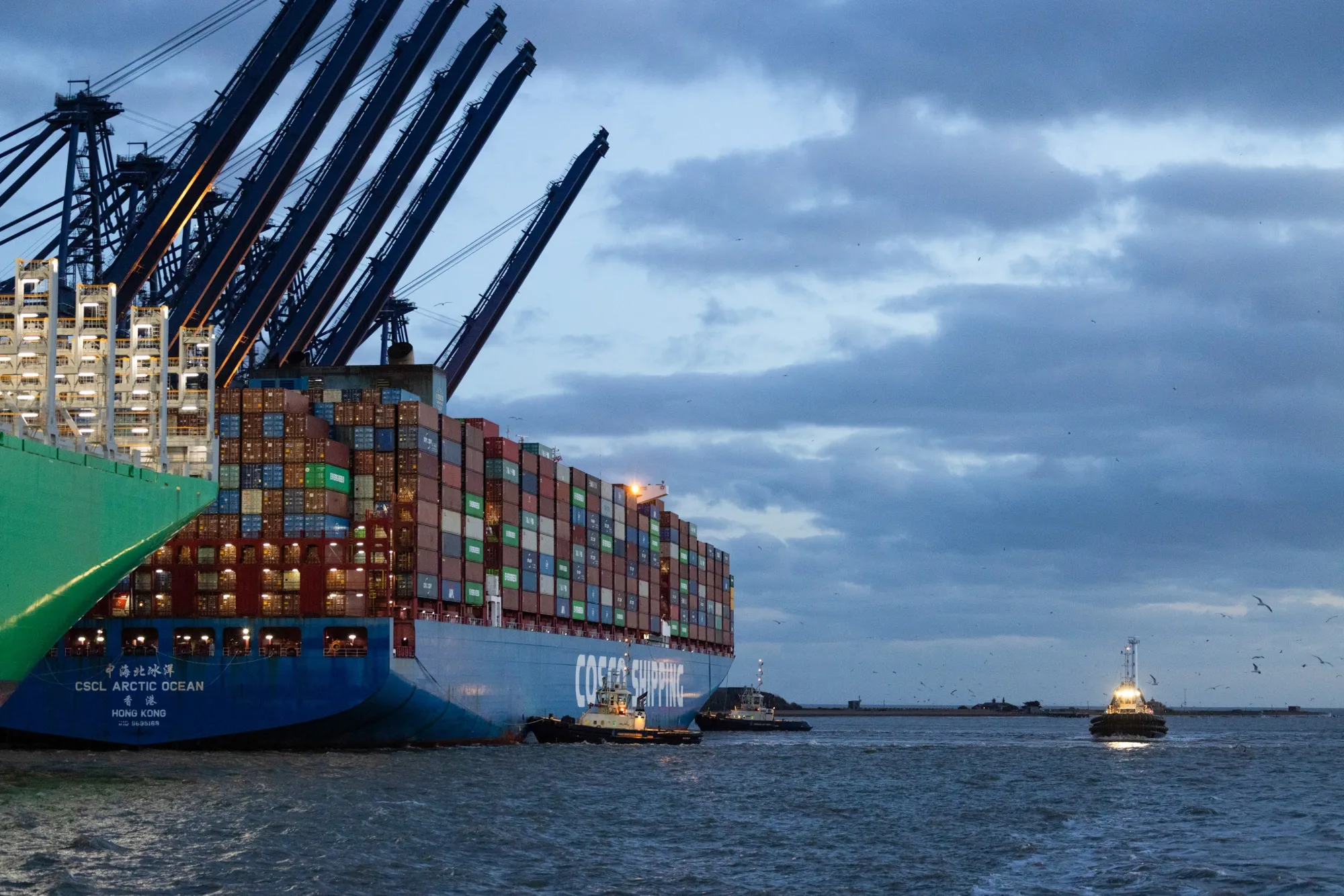 Tugboats, operated by Svitzer A/S, assist&nbsp;a container ship as it arrives at the Port of Felixstowe.&nbsp;