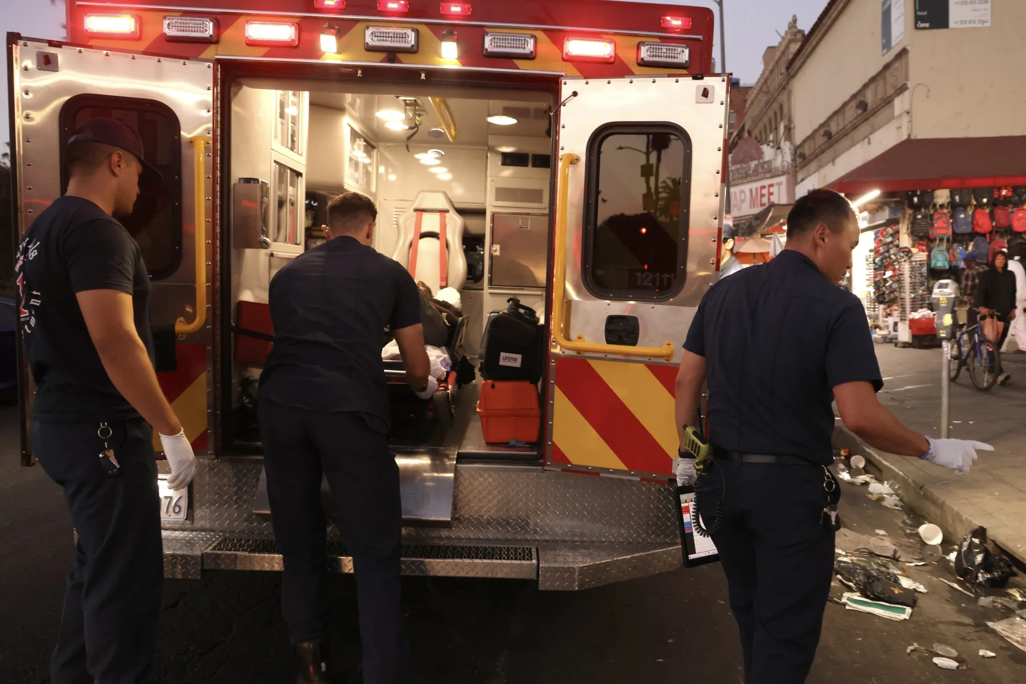 Emergency medical technicians and paramedics with Los Angeles Fire Station 11 prepare to take a patient to the hospital after being&nbsp;revived from a drug overdose with Narcan in October, 2024.