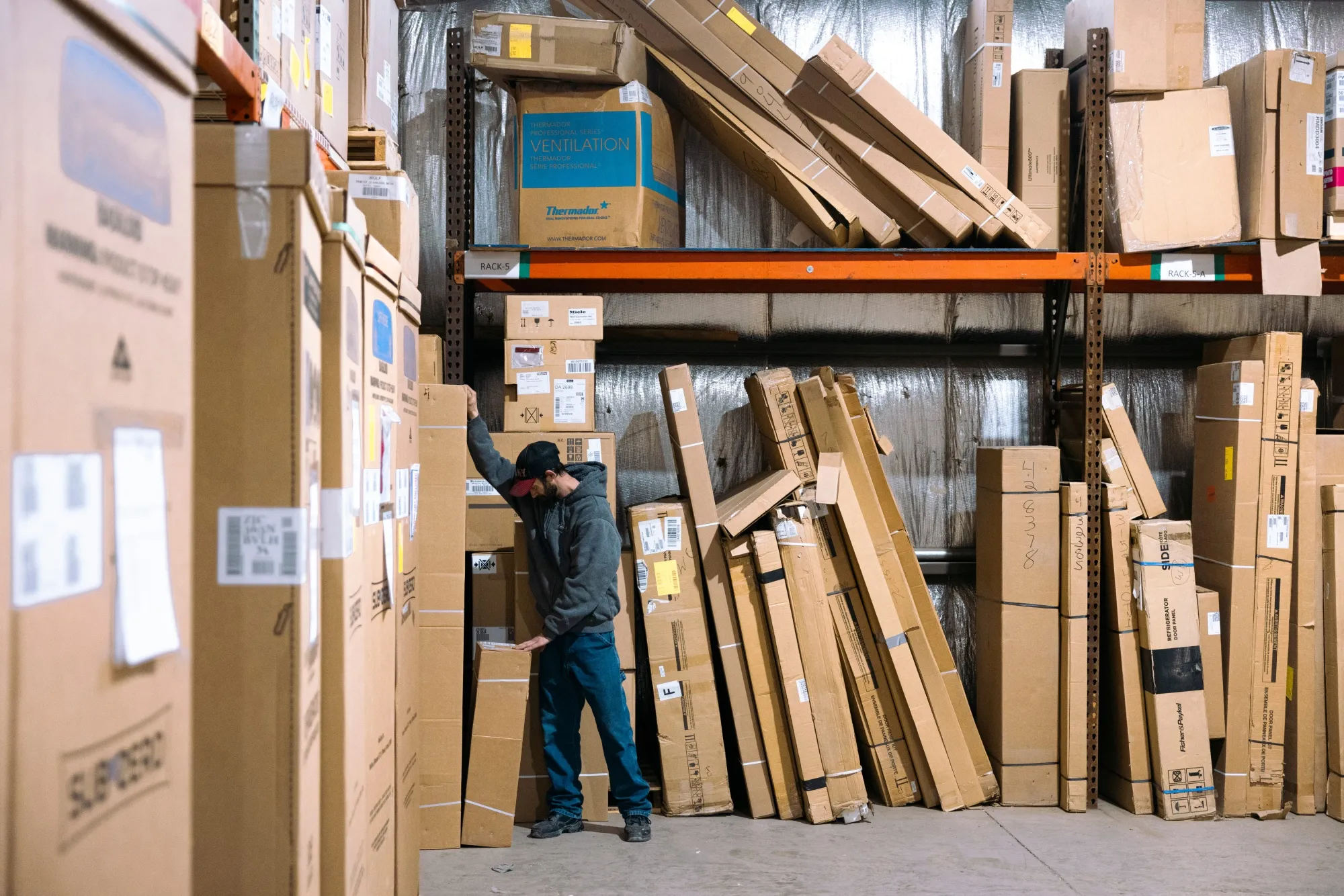 A worker sorts inventory in a warehouse in Latham, New York.