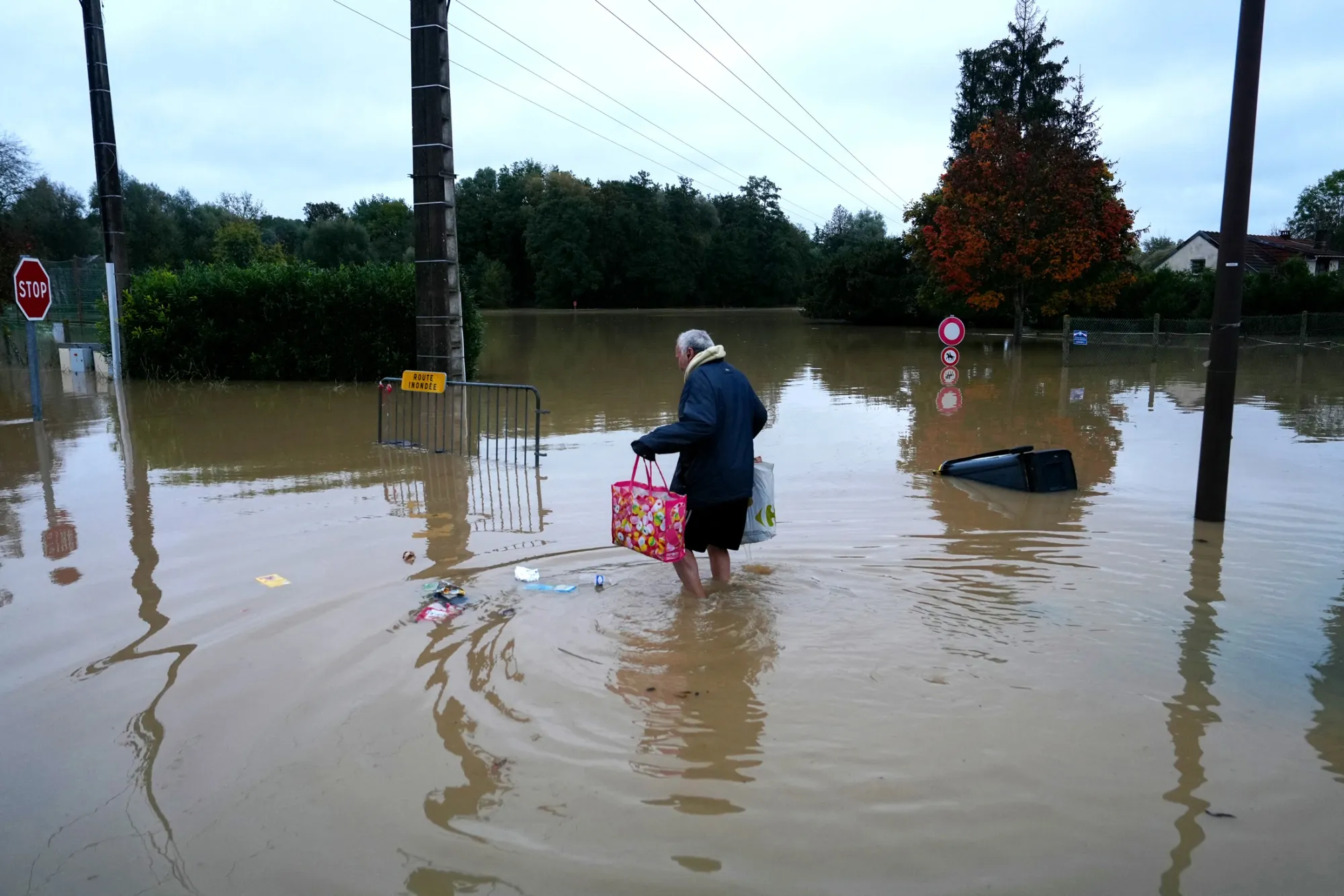 A resident walks through floodwaters in Pommeuse, east of Paris, on Oct. 10.
