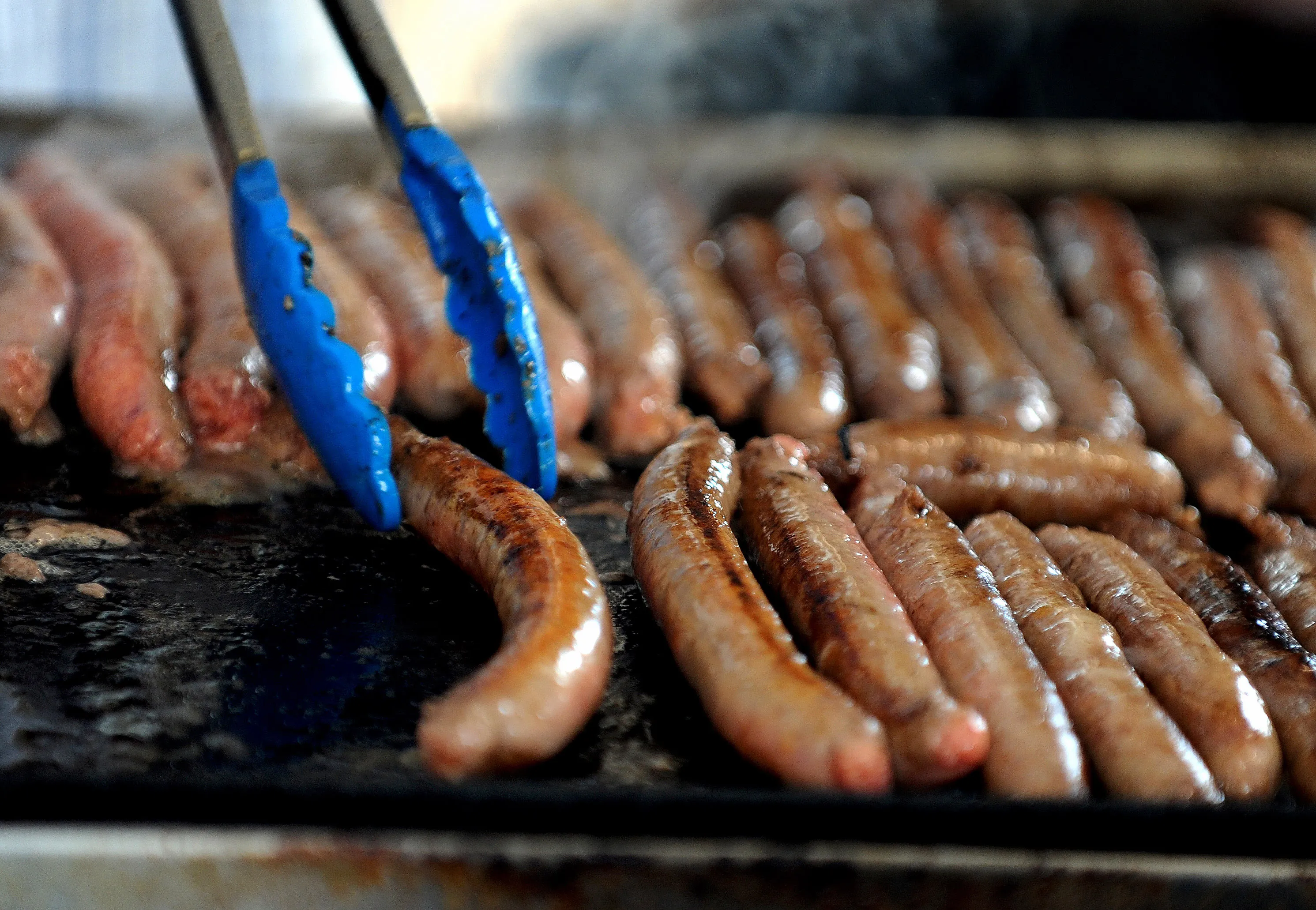 Sausages are cooked during the Guinness