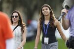 Sam Alexis Woods, right, daughter of Tiger Woods, walks with Wood's girlfriend Erica Herman during the first round of the PNC Championship golf tournament Saturday, Dec. 18, 2021, in Orlando, Fla. Woods has asked his daughter to introduce him for his induction to the World Golf Hall of Fame. (AP Photo/Scott Audette, File)