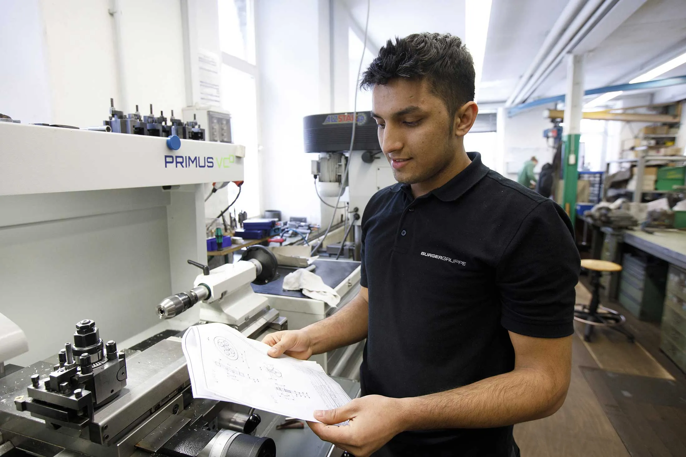 Obeid Allah Norzi, an 18-year-old refugee from Afghanistan, lives in an apartment owned by auto parts maker Burger Group.