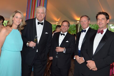 Jennifer Foster, assistant portfolio manager at Chilton Investments, and the firm's founder, Richard Chilton, with Russel Byer, Graham Foster and Todd Forrest, in charge of horticulture programs at the New York Botanical Garden. Photographer: Amanda Gordon/Bloomberg
