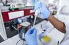 A scientist works in a molecular biology lab.