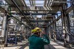 An employee inspects processing and refining structures in the Duna oil refinery in Szazhalombatta, Hungary, on May 24.