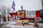 Signs hang from a snowplow during a protest near Belleville, Ontario, Canada, last year. Demonstrators disrupted railroads and other infrastructure to protest TC Energy Corp.’s planned Coastal GasLink pipeline.