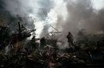 Ukrainian firefighters put&nbsp;out a fire after a strike in Zaporizhzhia, Ukraine, on Oct. 6.