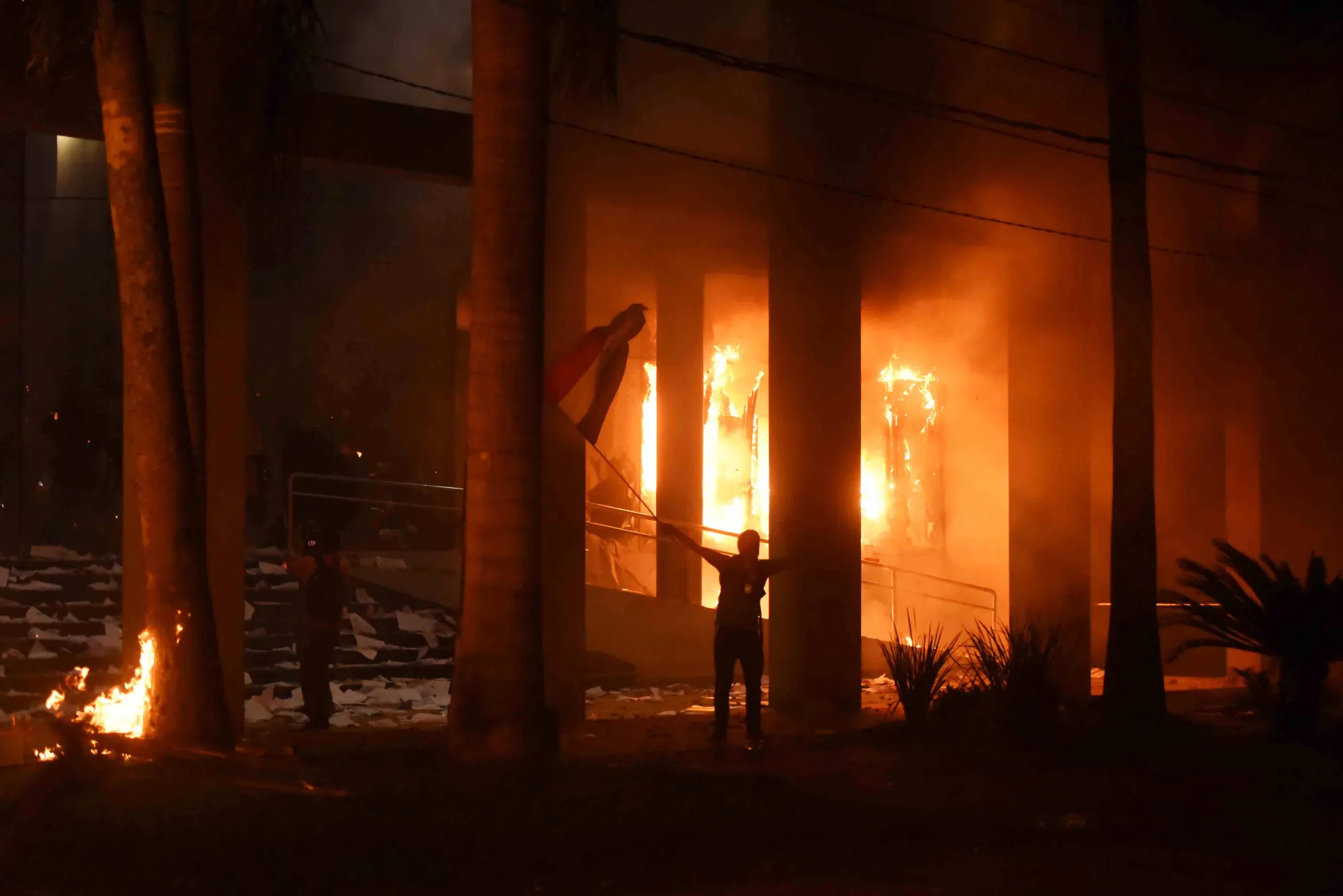 Hundreds of demonstrators protesting against the approval of a constitutional amendment for presidential reelection broke into the Congress building, battering down entrances and fences and shattering windows, and started to set fires inside, in Asuncion on March 31, 2017.Paraguayan senators on Friday approved a contested law allowing President Horacio Cartes to seek reelection in 2018, prompting furious protesters to break into the legislature, ransacking lawmakers' offices and starting fires. / AFP PHOTO / NORBERTO DUARTE (Photo credit should read NORBERTO DUARTE/AFP/Getty Images)
