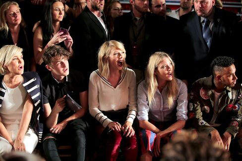 From left, Yolanda Hadid, Anwar Hadid, Taylor Swift, Martha Hunt, and Lewis Hamilton attend the Tommy Hilfiger Women's Fashion Show.