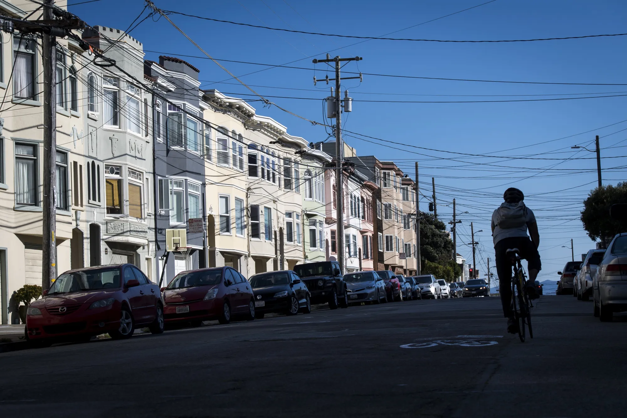 A cyclist rides past residential buildings in San Francisco on Sept. 12.&nbsp;