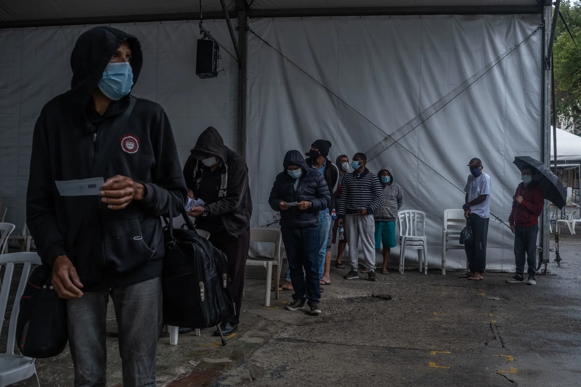 People wait in line to receive a dose of the Sinovac Biotech CoronaVac Covid-19 vaccine at a community shelter in Sao Paulo.