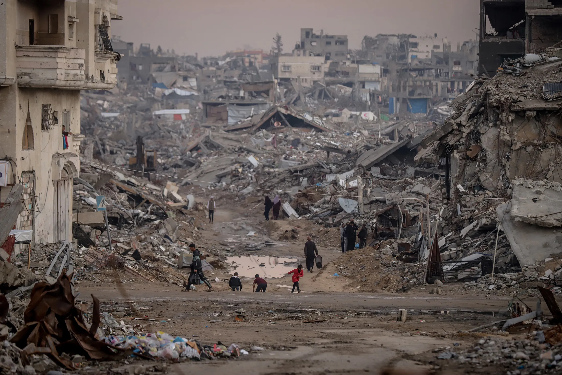 Palestinians walk amid the rubble of destroyed buildings in Gaza's Jabalia Camp&nbsp;on Nov. 16.