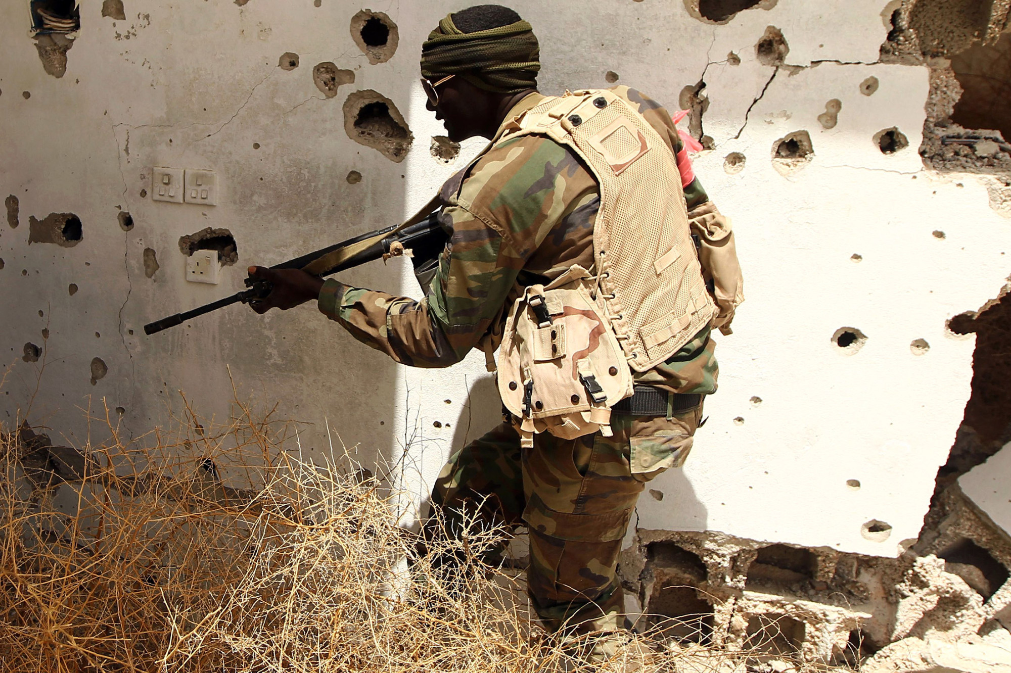 A member of the Libyan pro-government forces patrols a rural area on the outskirts of Benghazi, on April 19, 2016.
