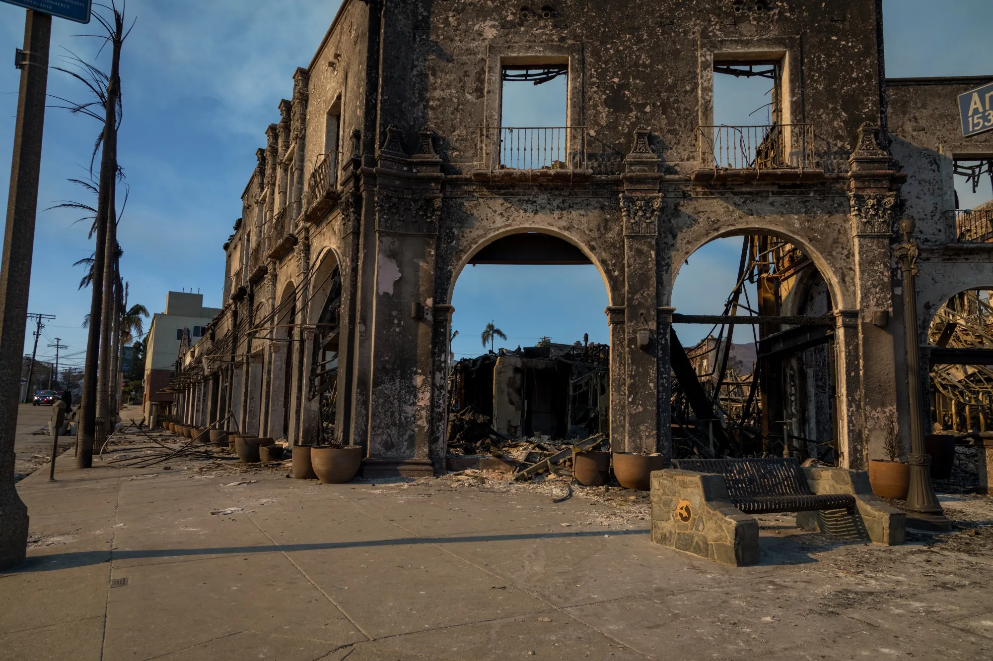 The charred remains of a restaurant occupies a corner of Sunset Boulevard following the Palisades Fire in the Pacific Palisades area of Los Angeles.