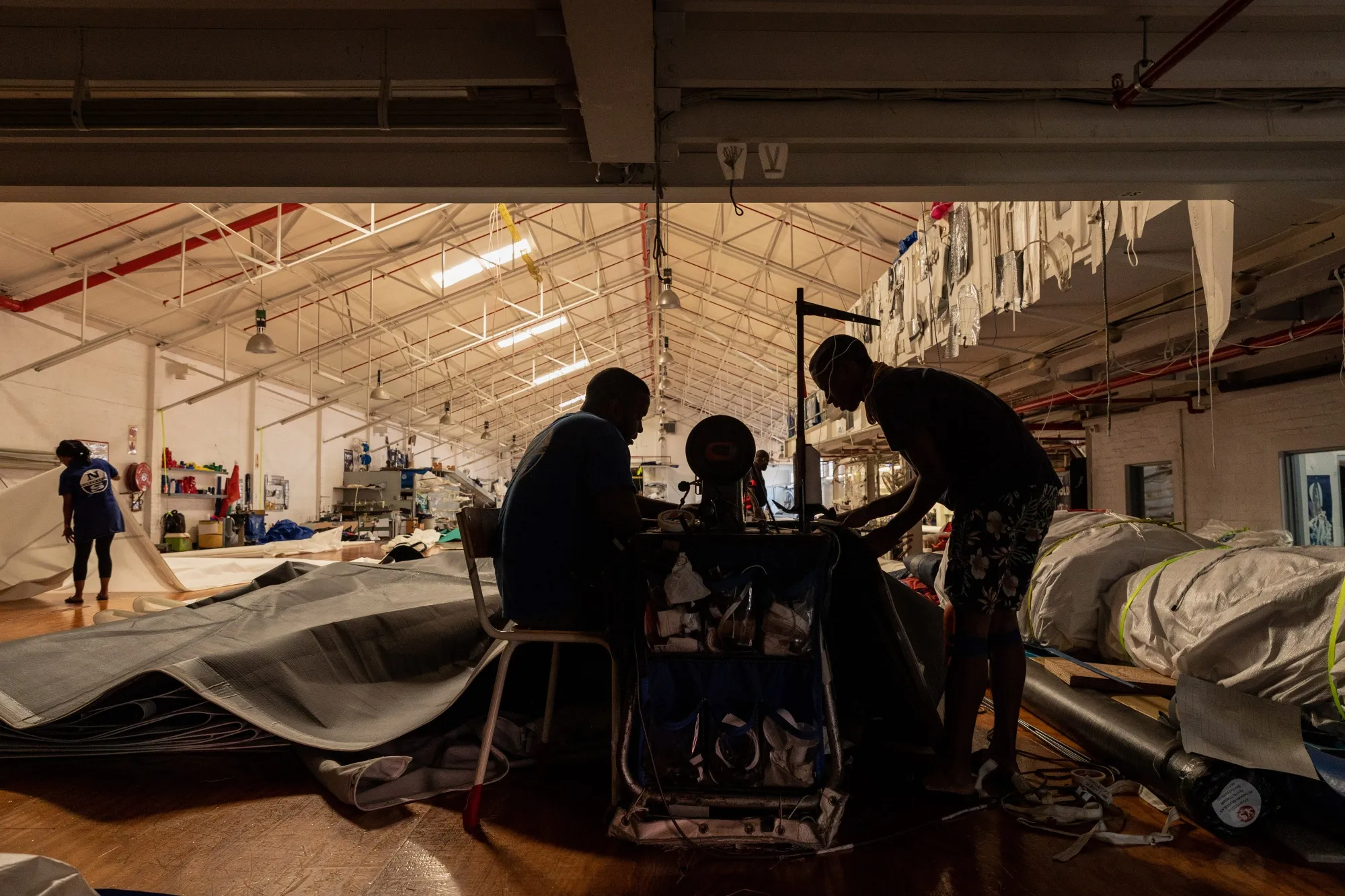Employees work at a sewing machine, powered by a generator, during a load-shedding power outage period at a sailmaker in&nbsp;Cape Town, South Africa.
