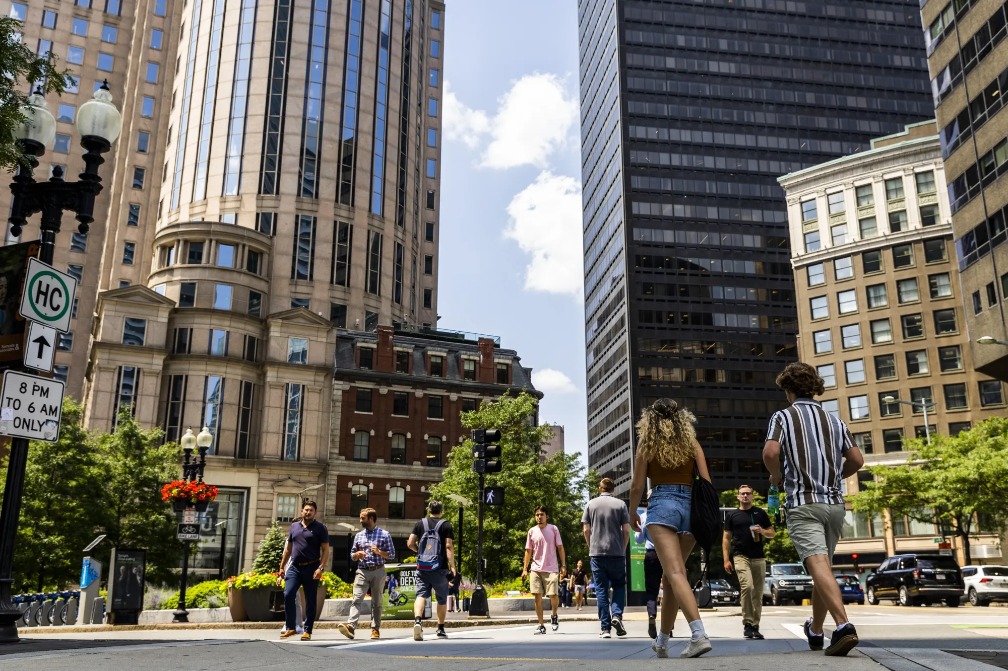 Pedestrians walk past commercial real estate at&nbsp;the South Station Train Terminal in downtown Boston, Massachusetts.