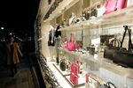A pedestrian looks at a display of handbags, purses and accessories the window of a Michael Kors Holdings Ltd. store as she walks past the store in the Omotesando district of Tokyo, Japan, on Friday, Nov. 22, 2013.
